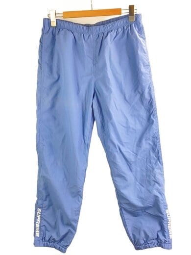 商品画像：spellout Embroiderred track pants/ボトム/M/ナイロン/BLU/無地 1